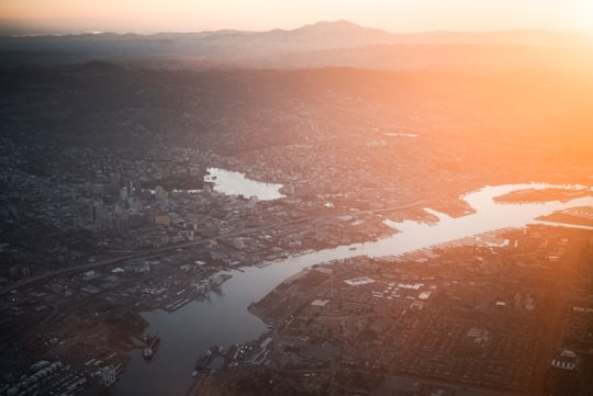 aerial photo of cityscape near river at daytime in Oakland United States