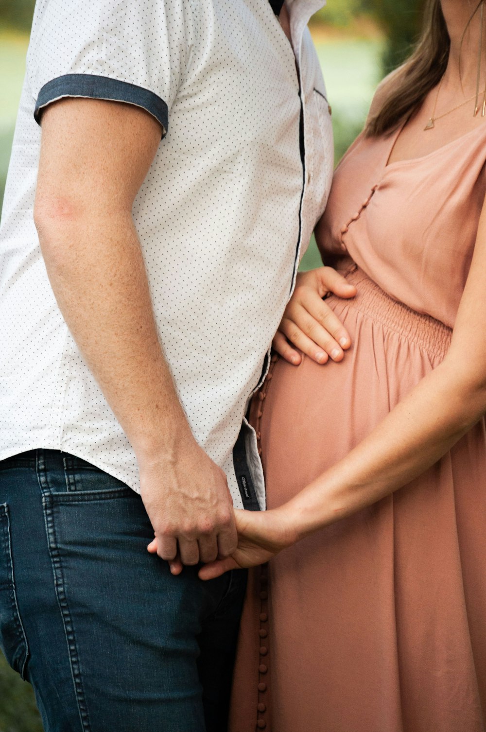 man holding pregnant woman