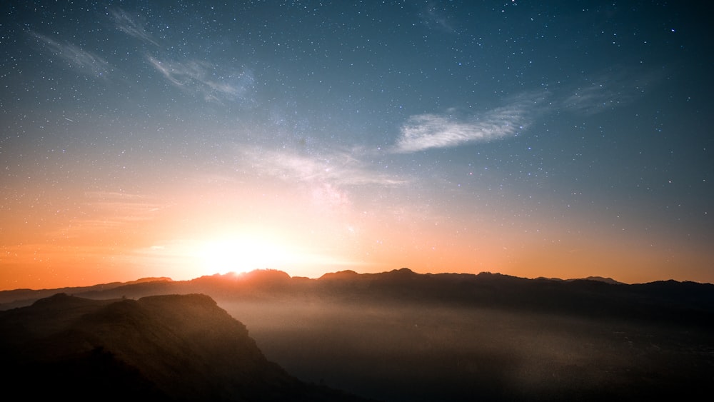 silhouette of mountains during sunrise