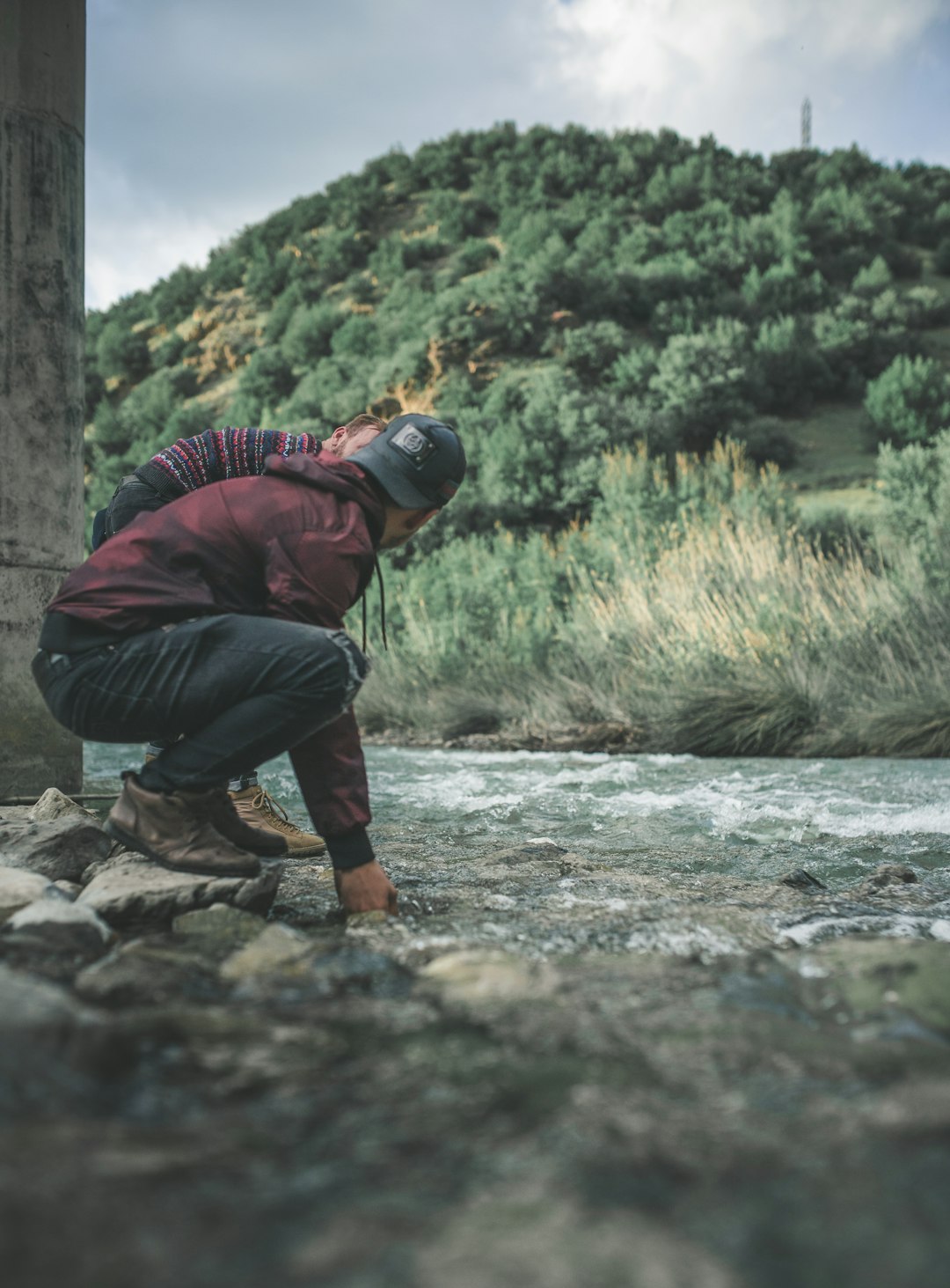 man washing hands in river