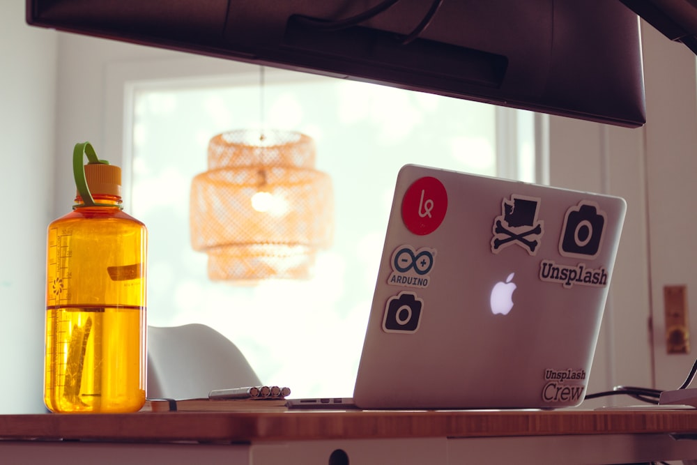 white laptop computer and tumbler