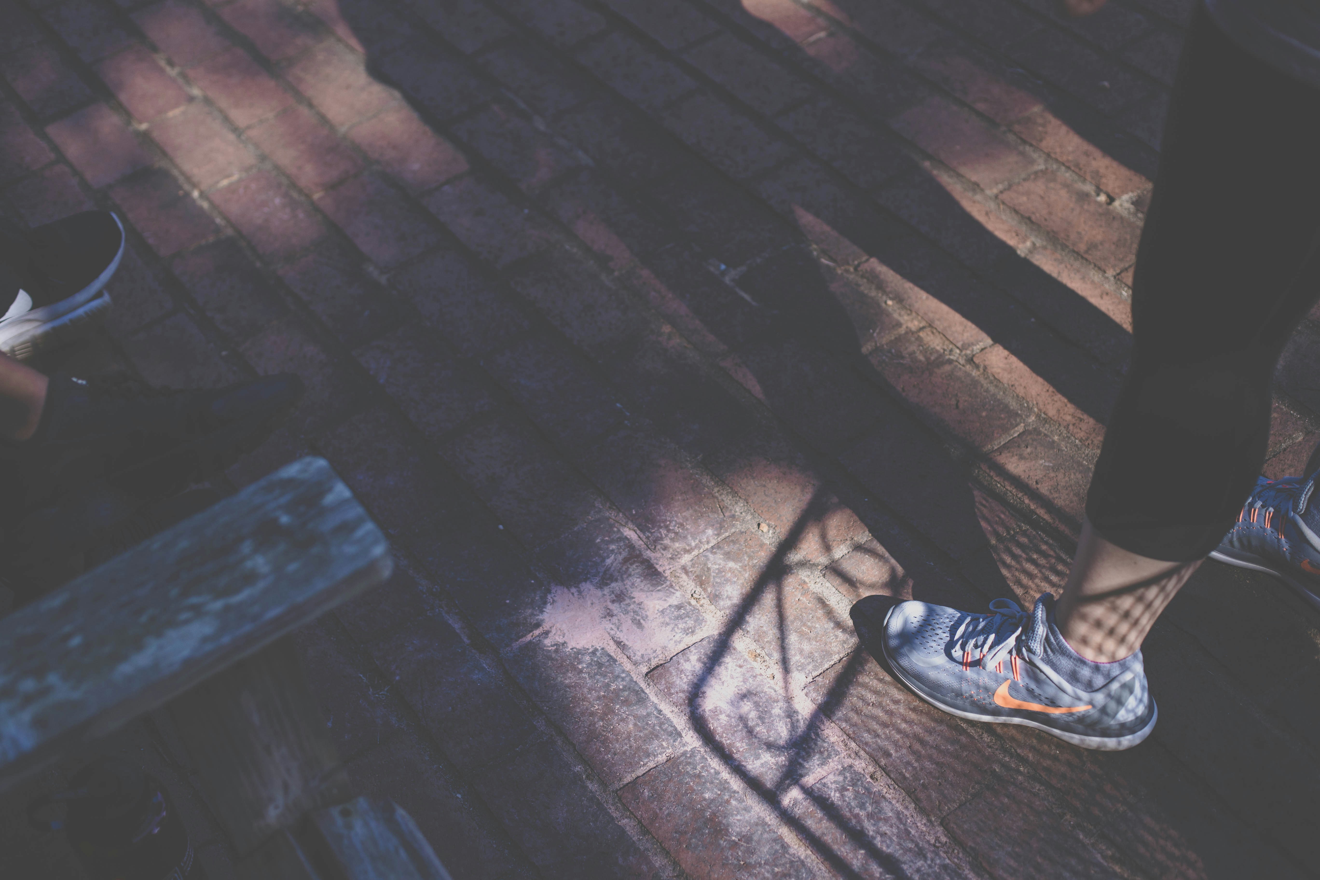 person wearing gray Nike shoes