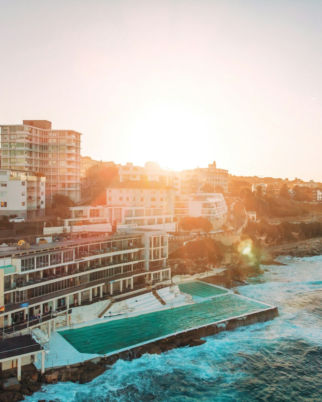 high-angle photography of buildings and body of water at daytime