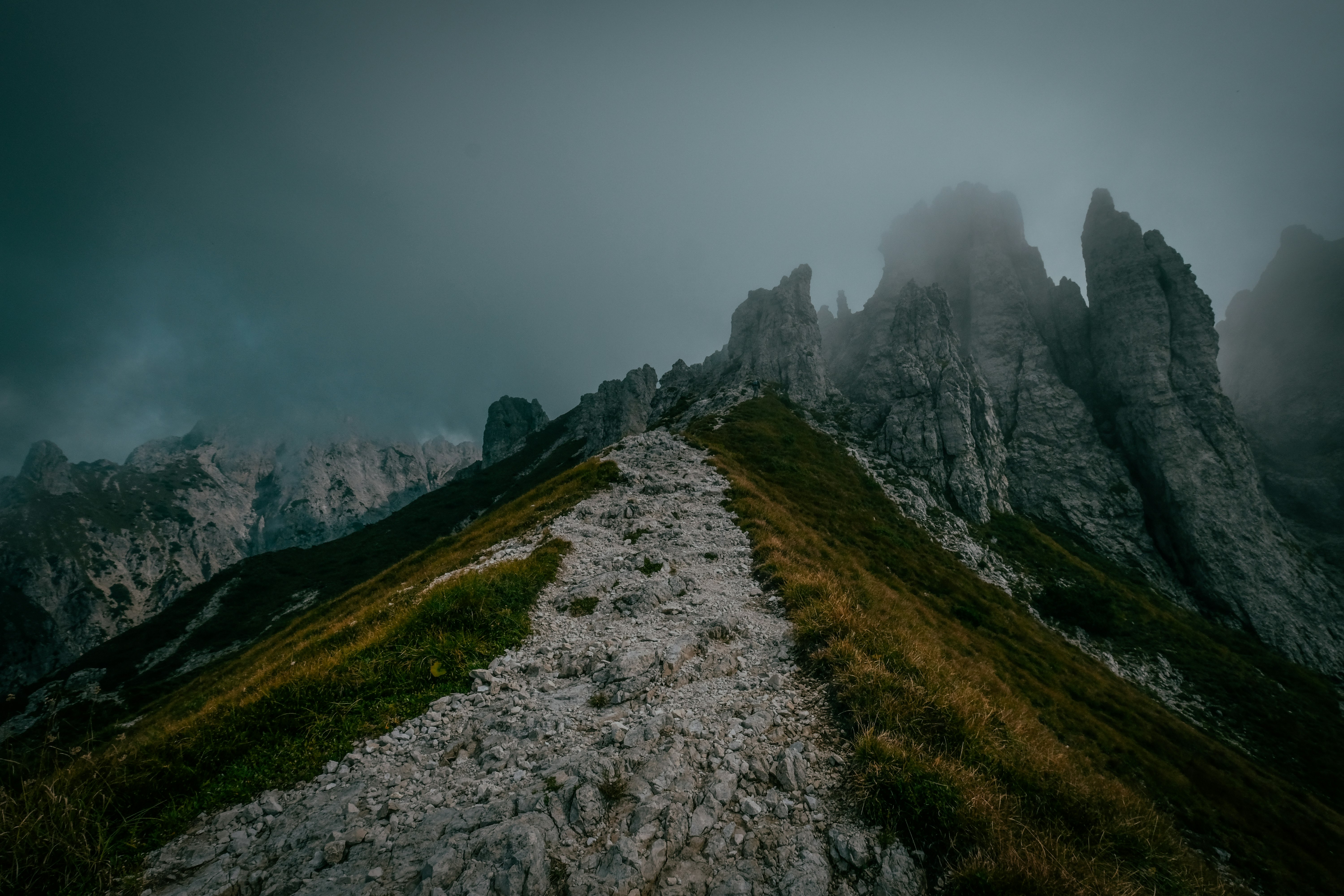 mountain peak trail surrounded with fogs