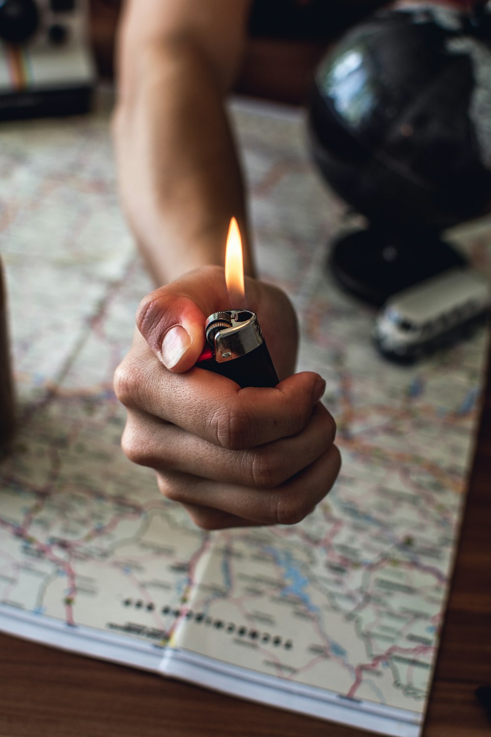 person lights black BIC disposable lighter