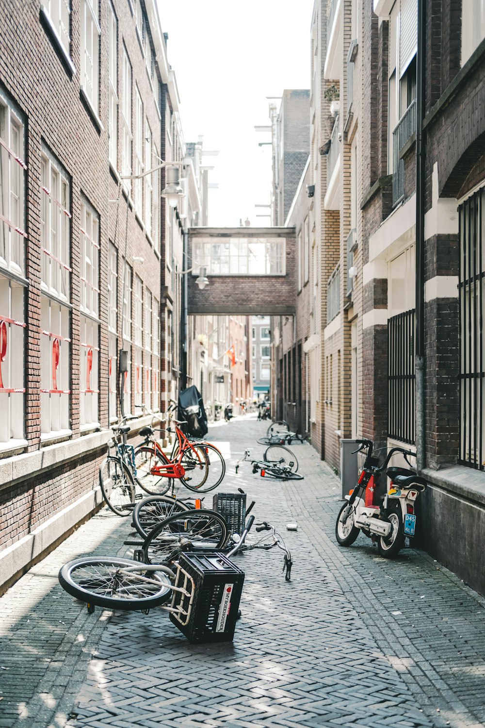 parked bicycles between concrete buildings
