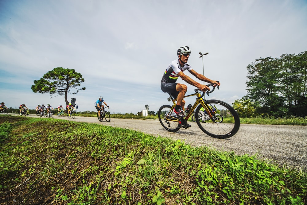 group of men biking on dirt road