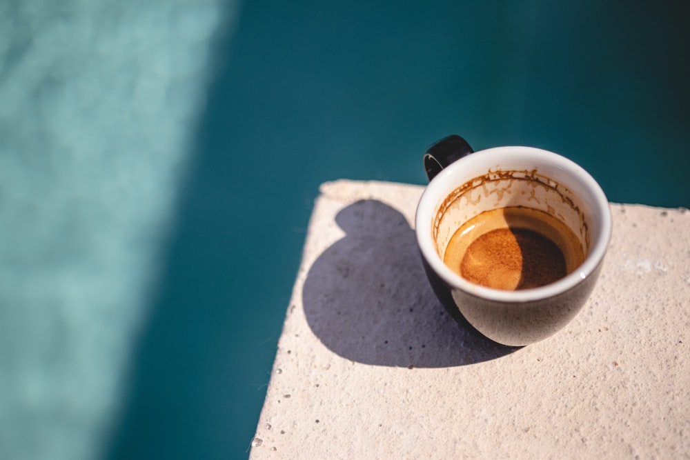 coffee mug filled with brown liquid