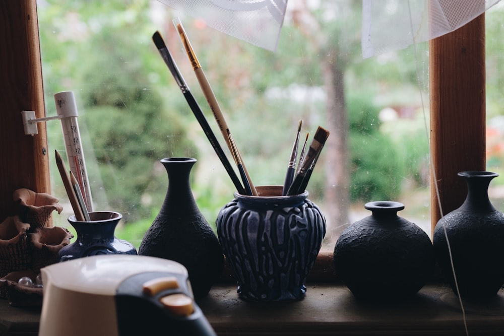 paintbrushes in ceramic jar