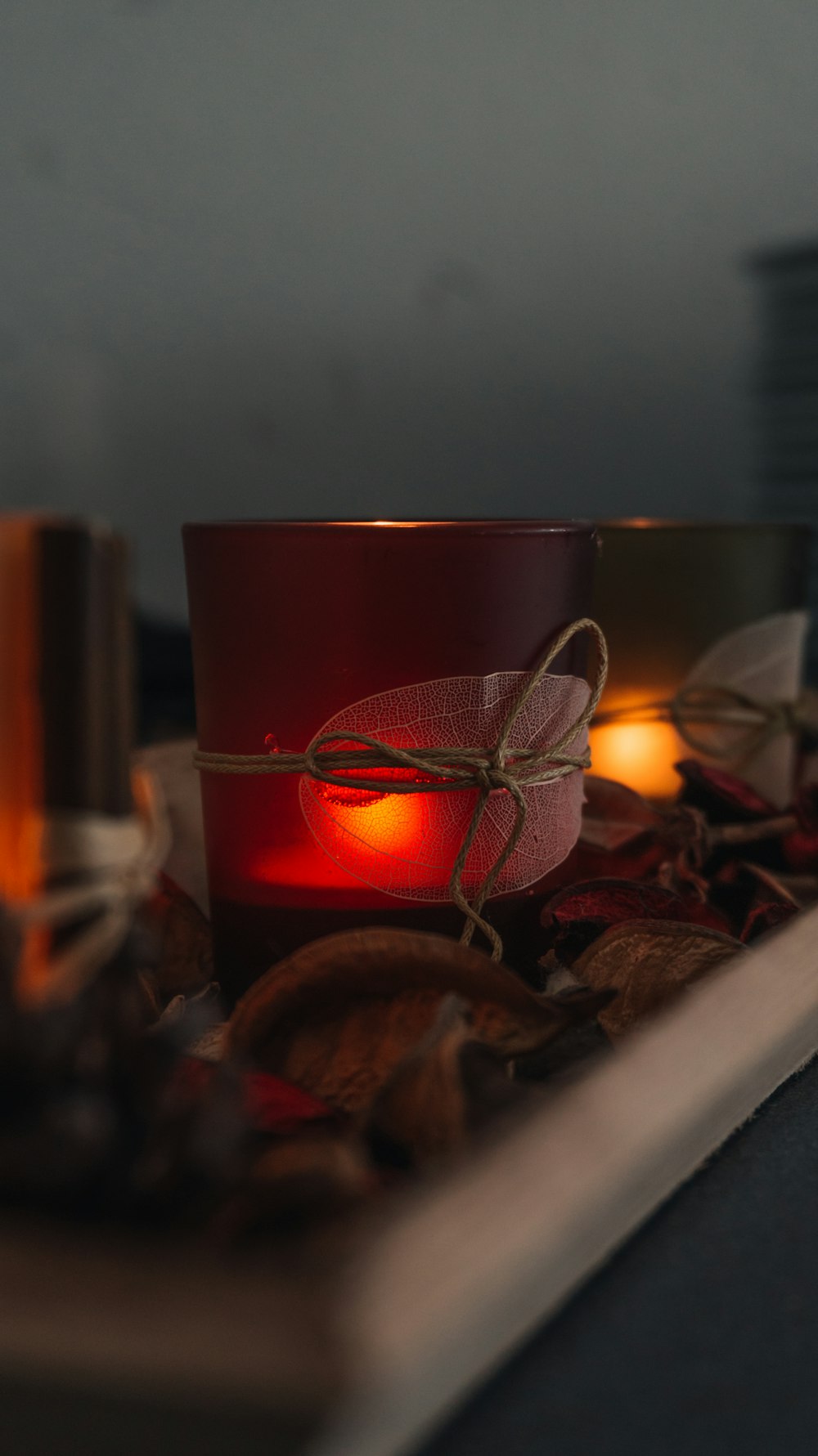 red tealight candle on table