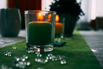 A Gratitude candle lit and surrounded by soothing decor.