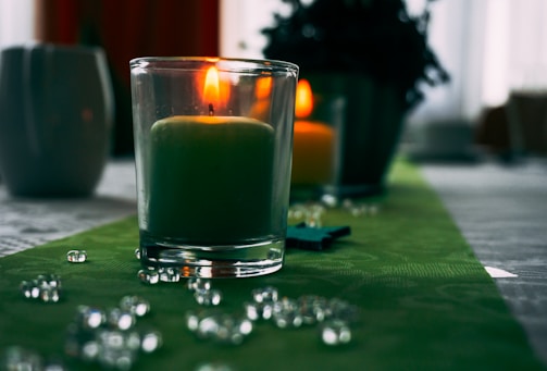 A Gratitude candle lit and surrounded by soothing decor.