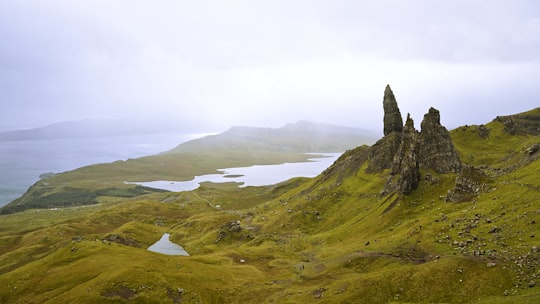mountain beside body of water in Old Man of Storr United Kingdom
