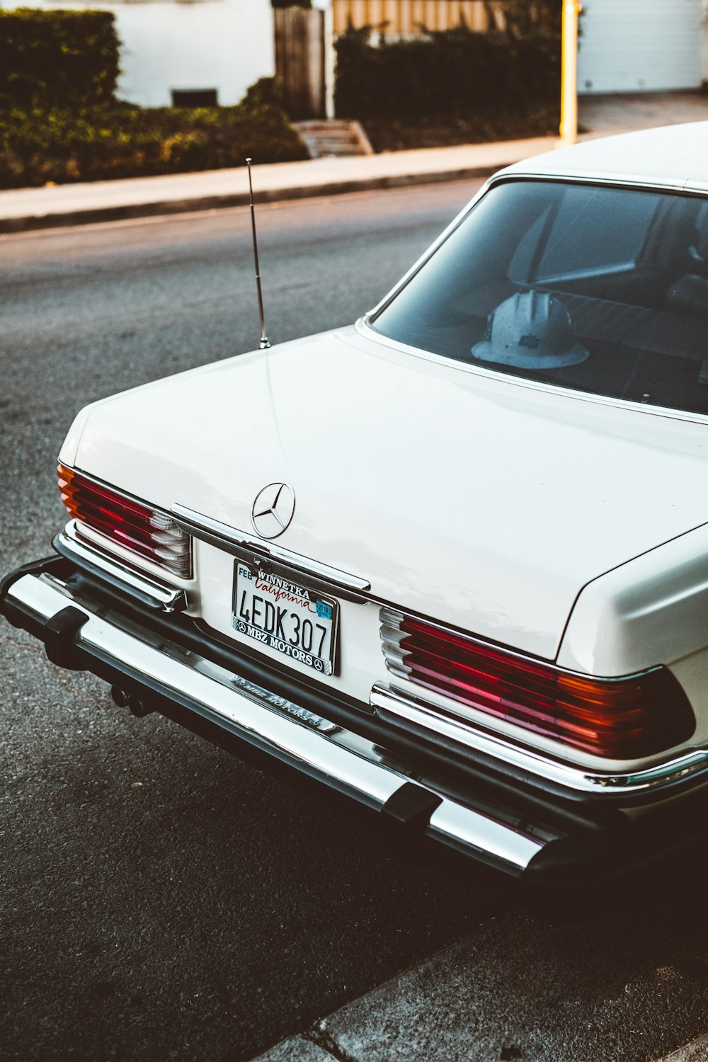 white Mercedes-Benz car parked on road