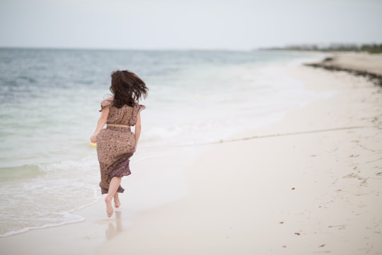 woman running on shoreline in Isla Mujeres Mexico