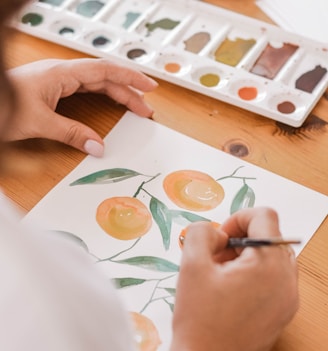 person painting a orange fruits