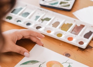 person painting a orange fruits