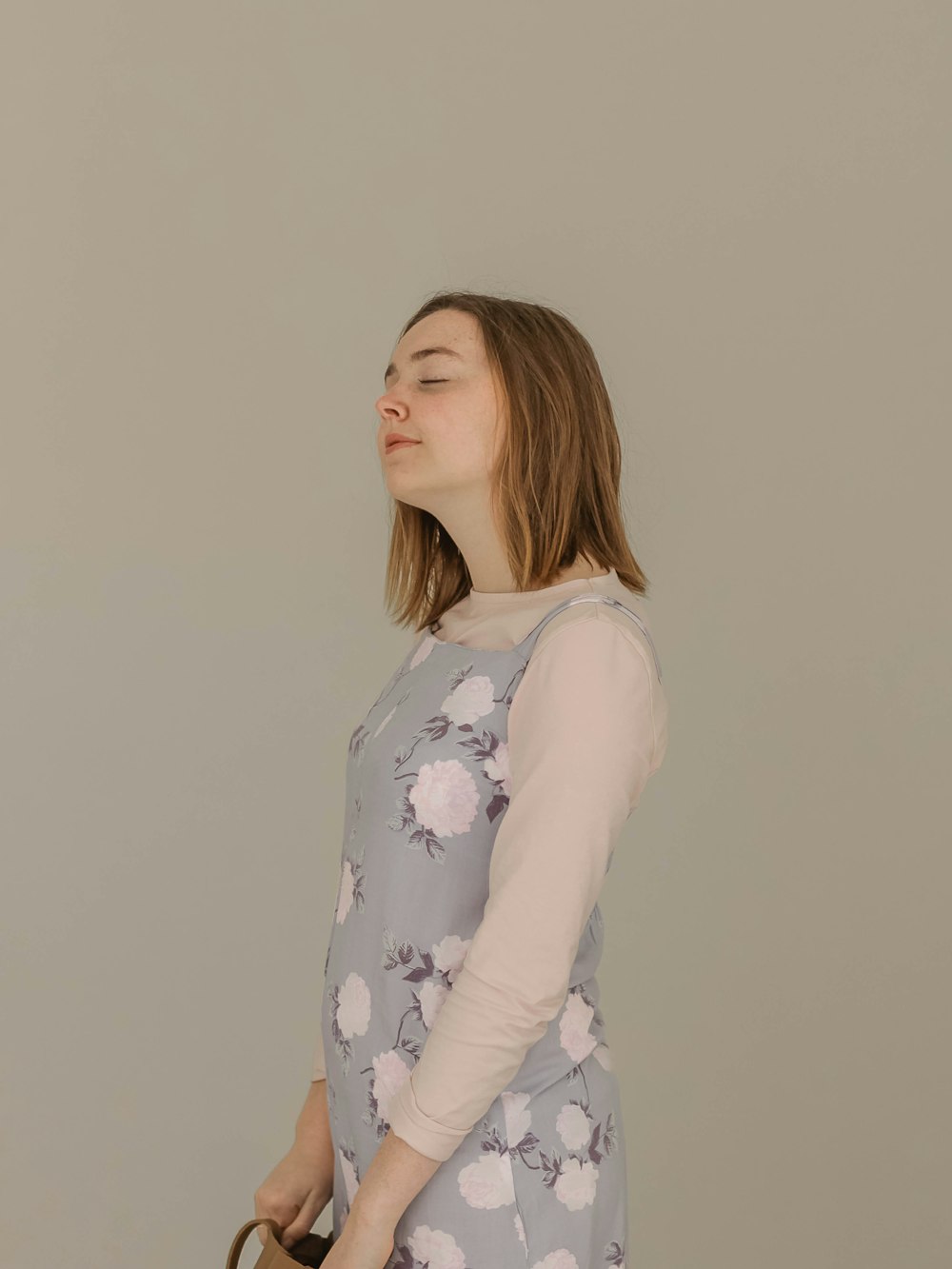 standing woman beside wall