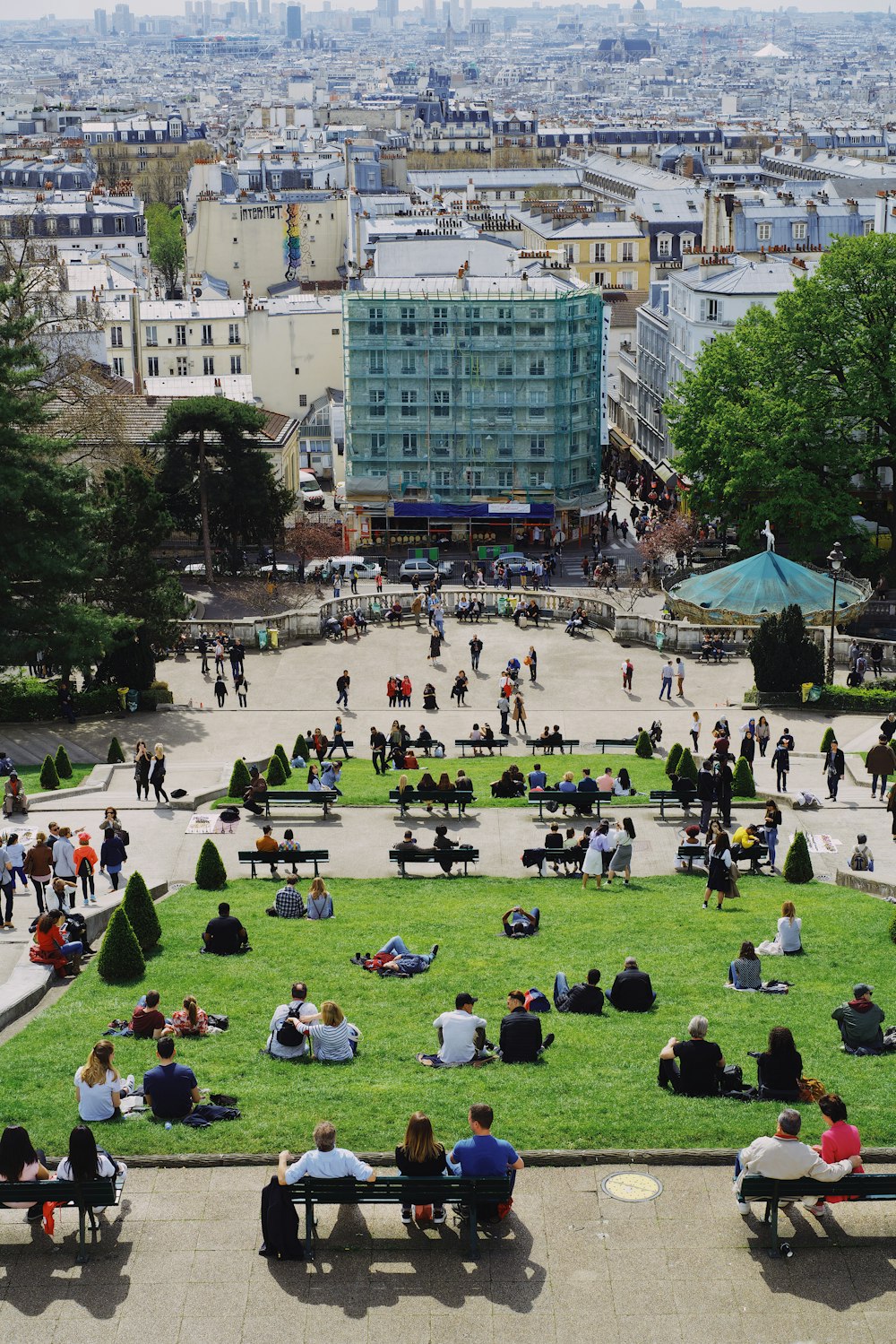 people on part facing buildings