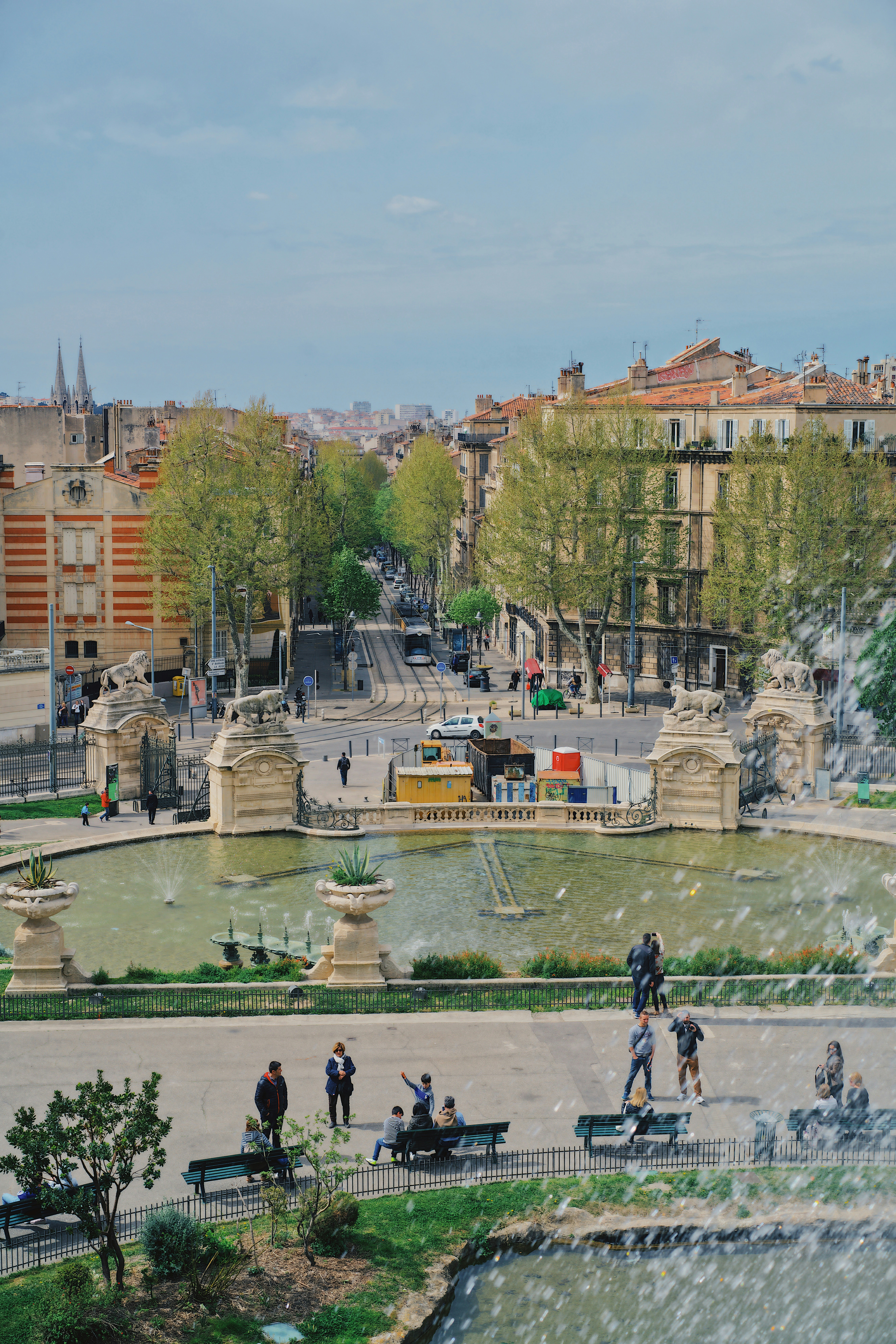 aerial photography of people in a park fronting a water fountain