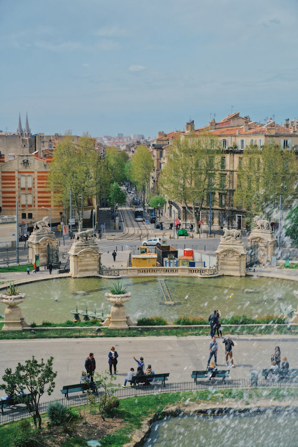 aerial photography of people in a park fronting a water fountain