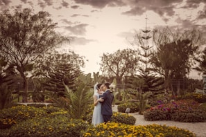 A romantic image of the couple embracing in a beautiful garden.