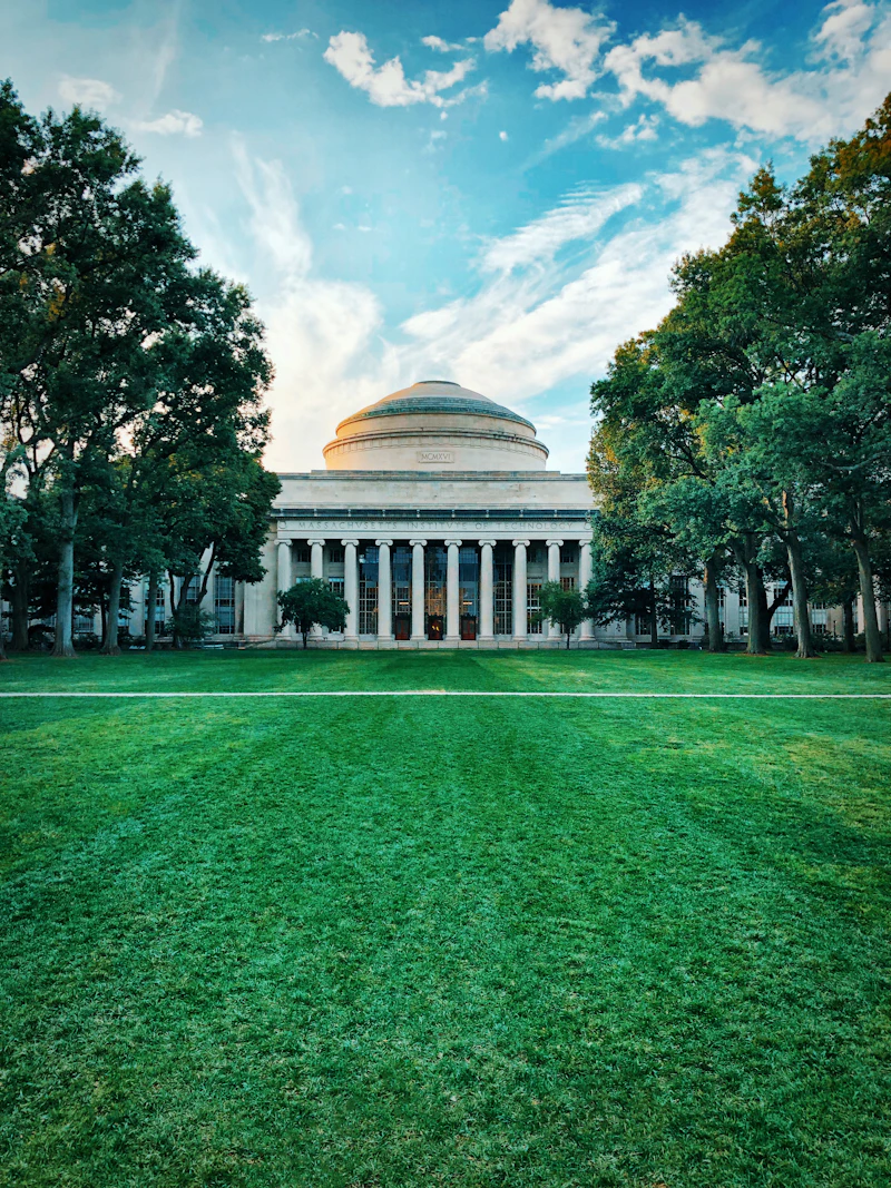 Grey stone domed university building in daytime