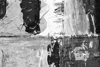 A minimalist dark painting with sharp contrasts and textured brushstrokes.