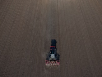 A John Deere tractor plowing a field with precision.