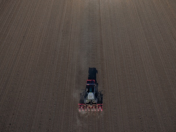 A John Deere tractor plowing a field with precision.