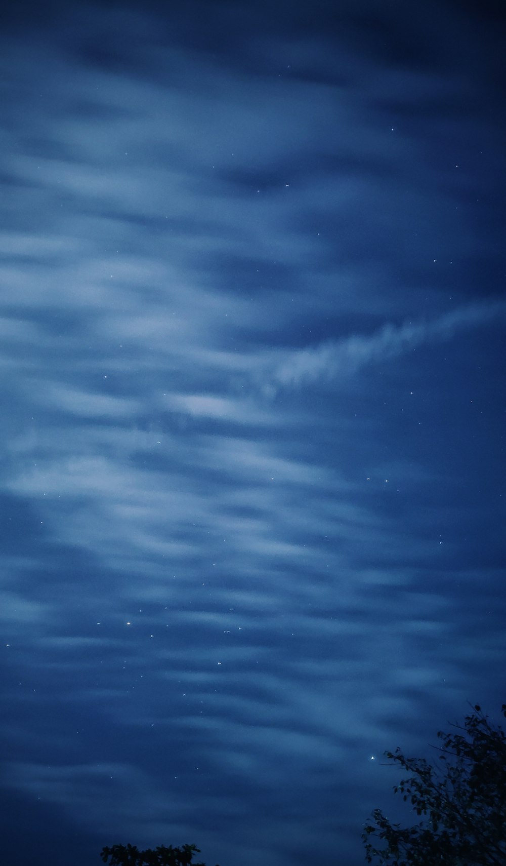 white clouds under blue sky at nighttime photo