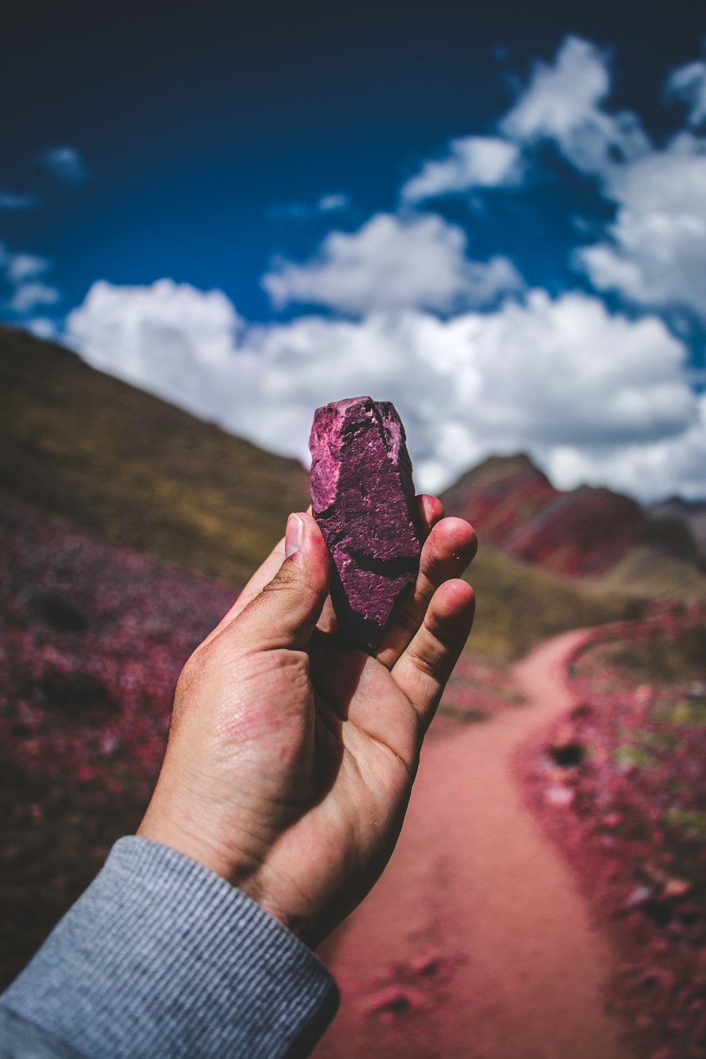 person holding pink stone