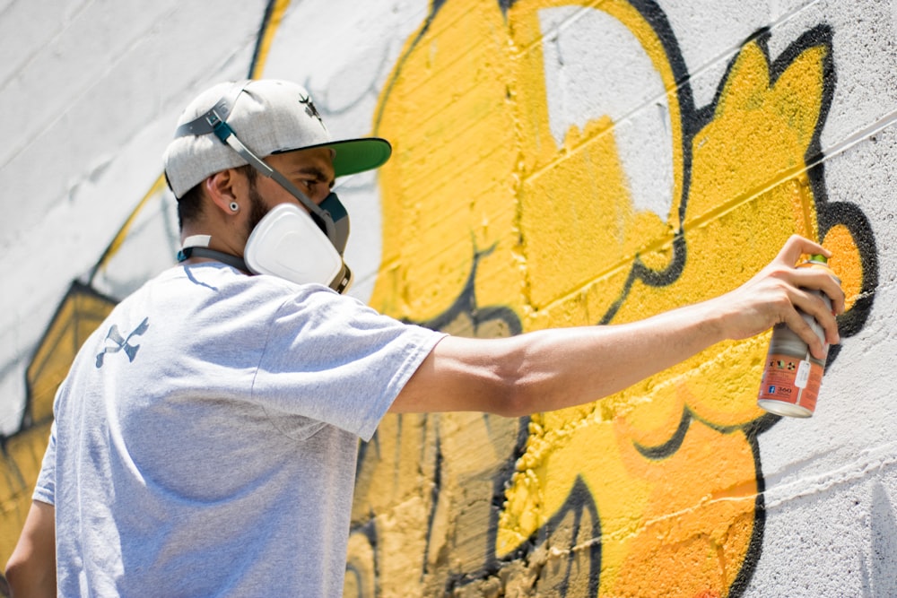 man spraying on wall