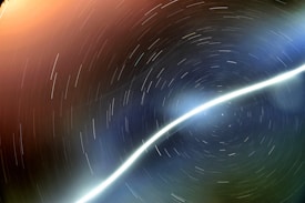 Long exposure photograph capturing star trails in the night sky, creating circular patterns around a central point with a prominent diagonal light streak.