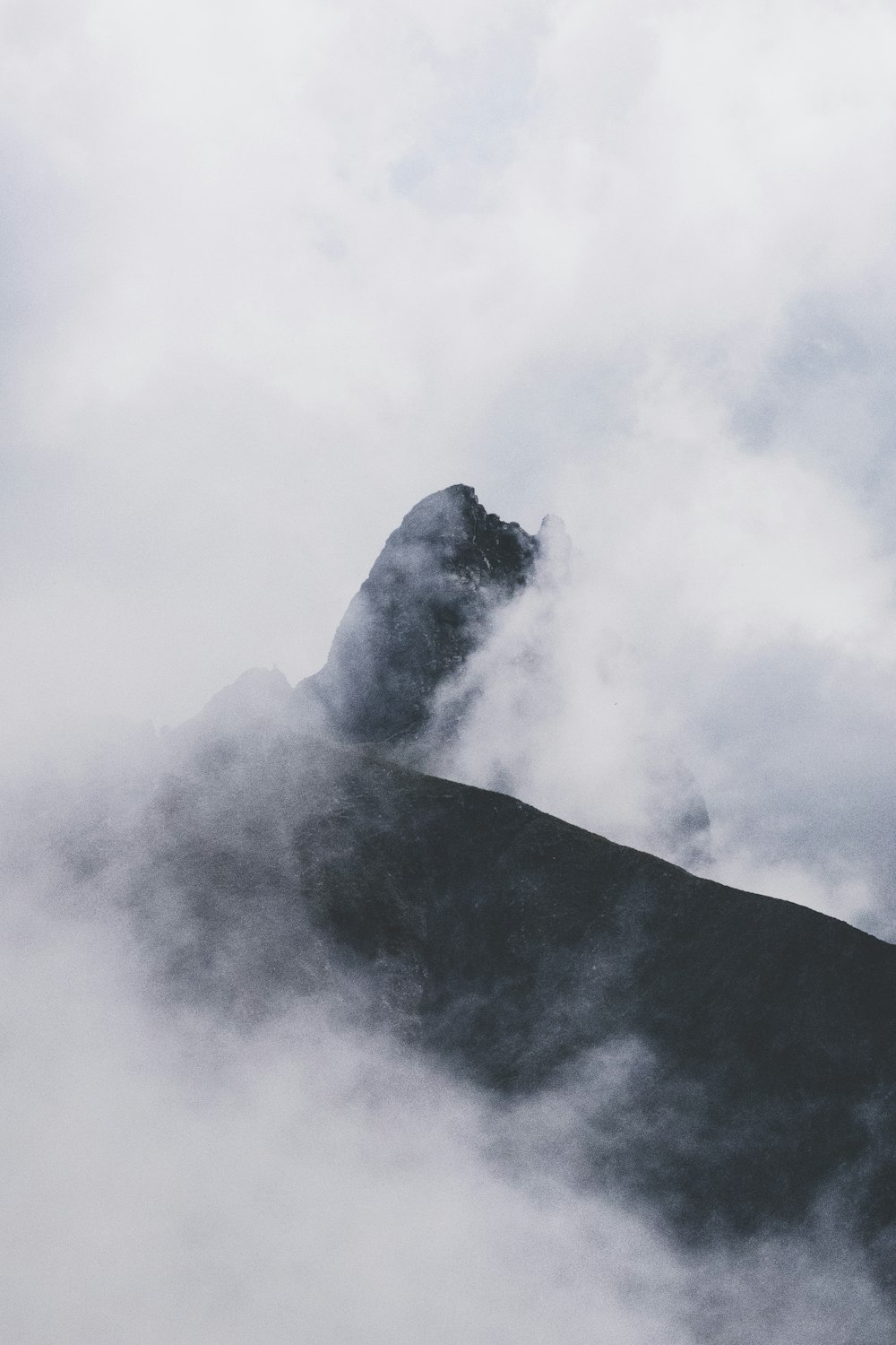 black mountain and white fog