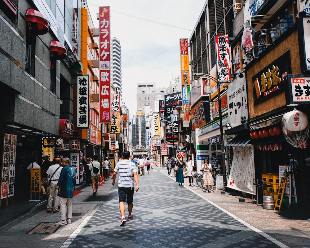 people walking in front of stores during daytime