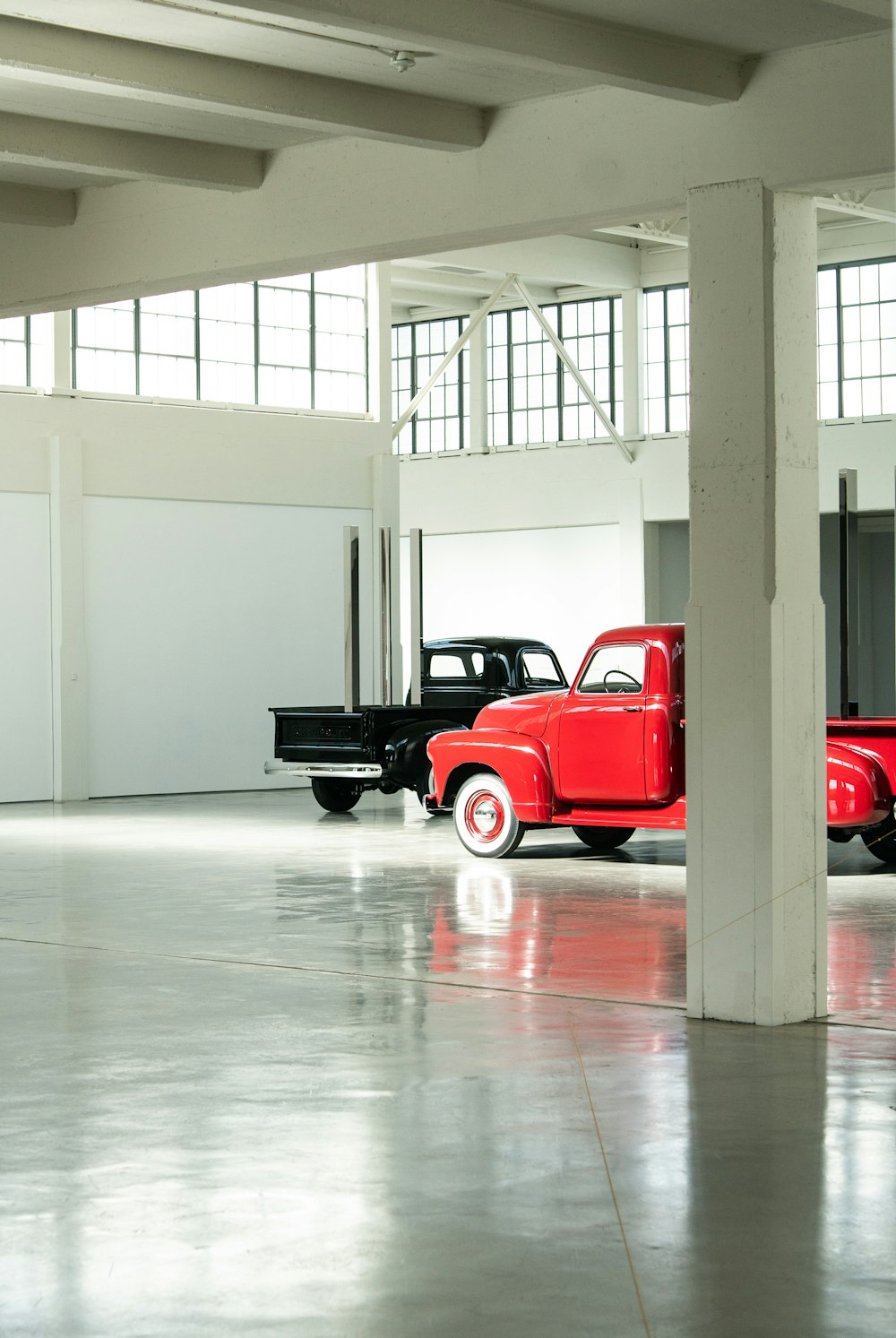 two parked red and black pickup trucks