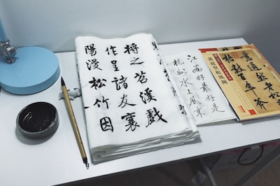 A serene workspace with Japanese calligraphy tools and financial charts.