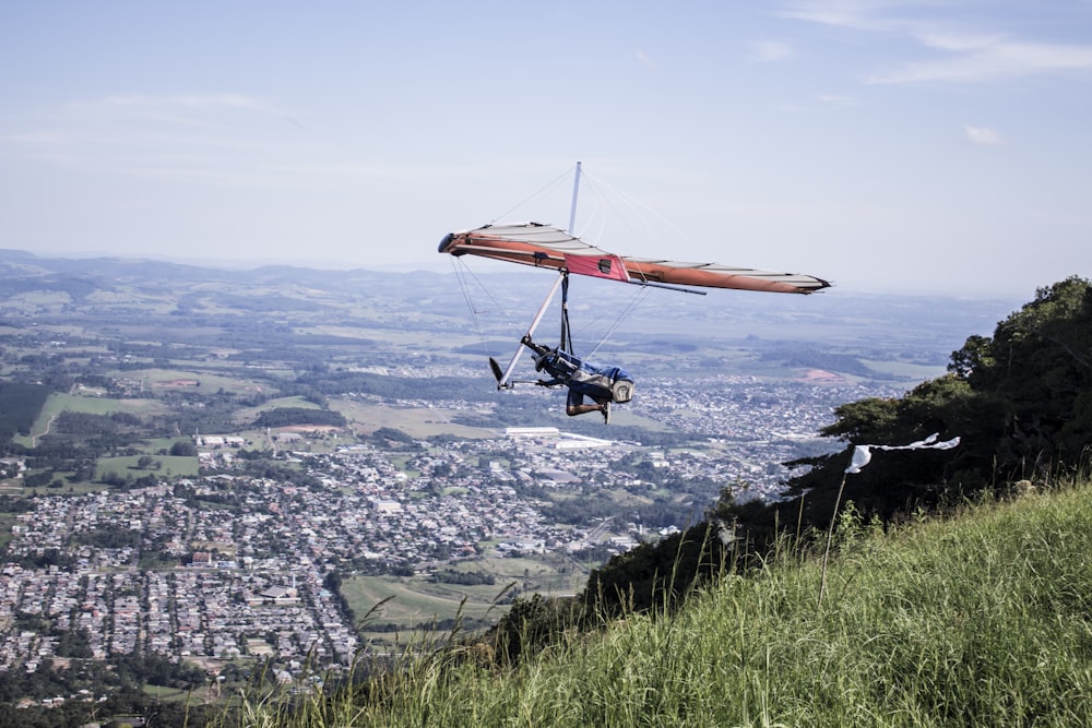 man riding paragliding over mountain