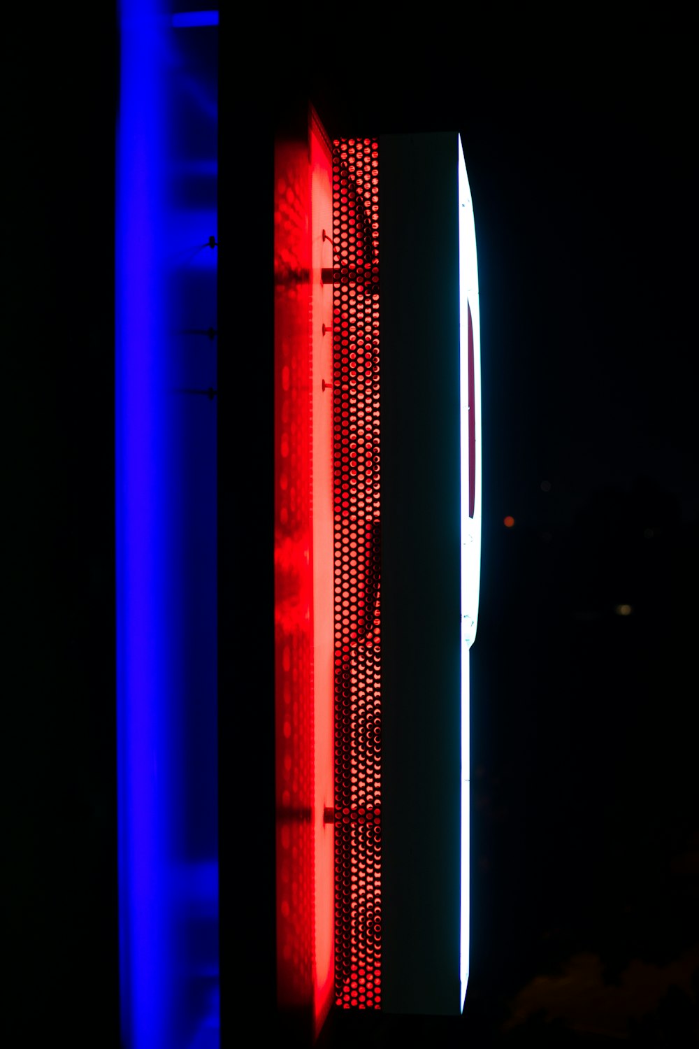 a red, white and blue light shines in the dark