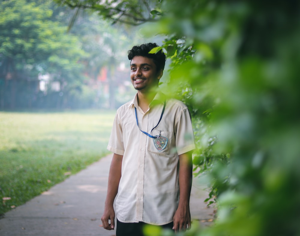 man standing beside tree