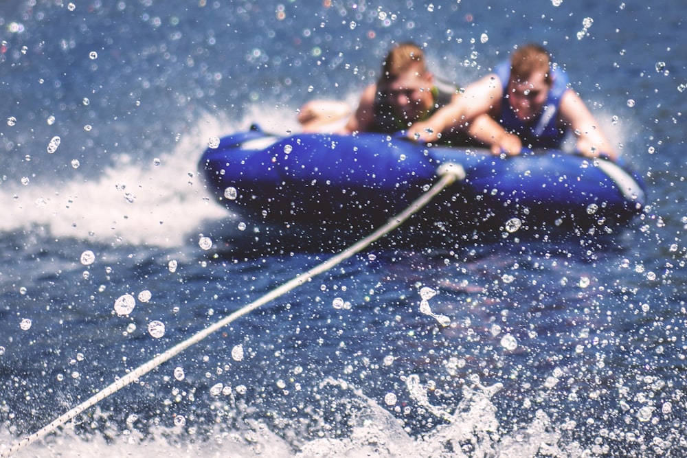 two men riding on inflatable boats