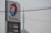 A tall sign for Total with the company's logo and current petrol and diesel prices. The backdrop includes an overcast sky and visible power lines overhead.