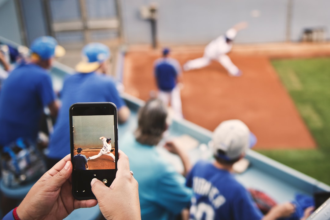 selective focus photo of phone displaying baseball player