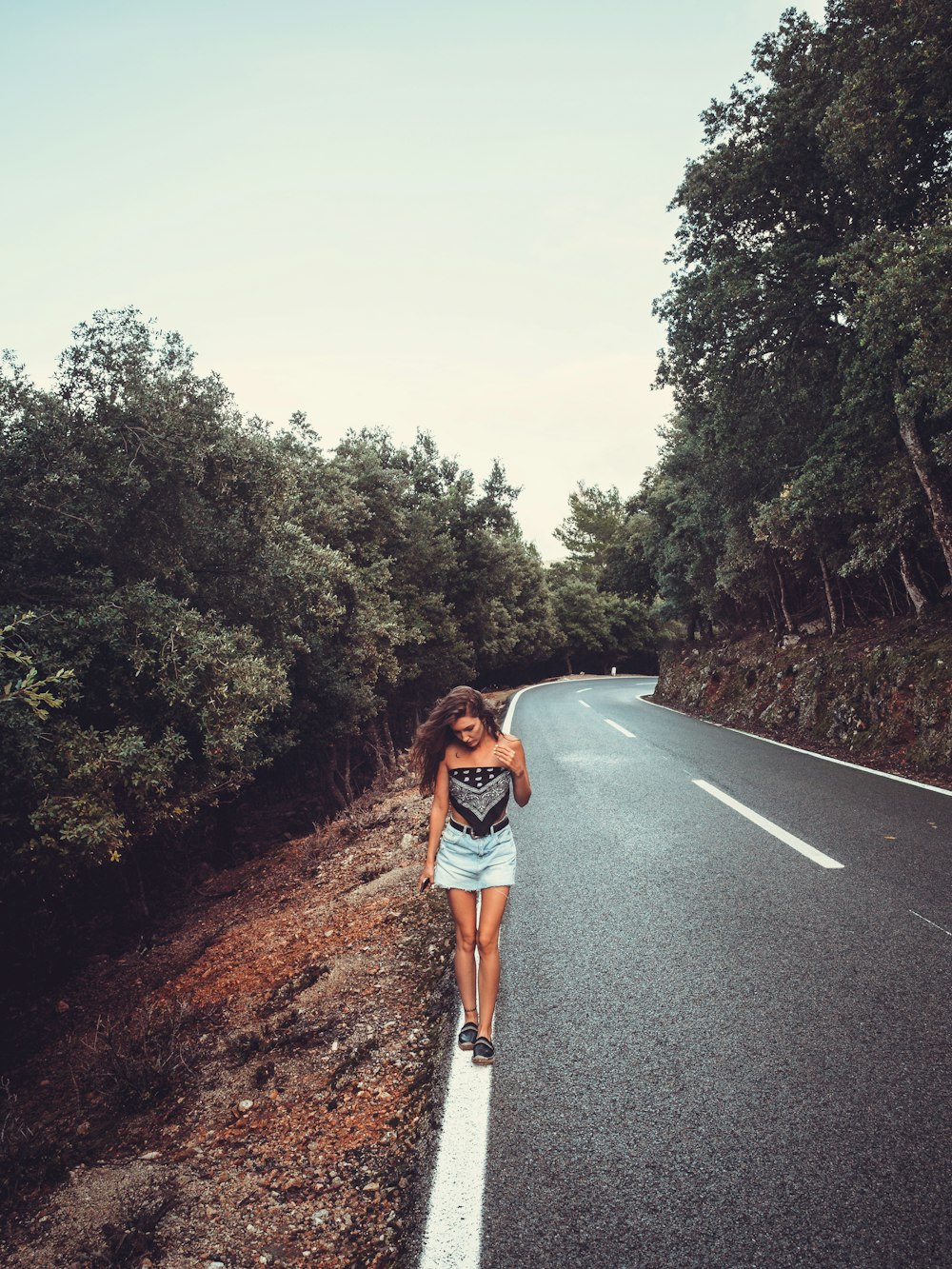 woman standing on road during daytime