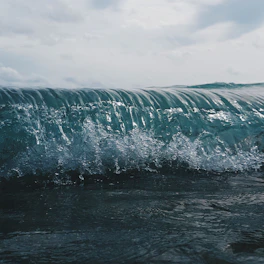 A dynamic wave pattern illustrating light refraction through a prism