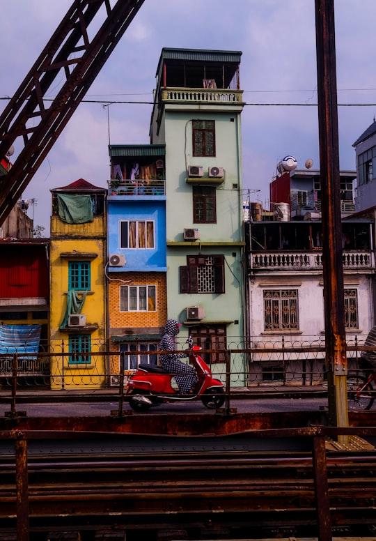 man riding motor scooter in cầu Long Biên Vietnam