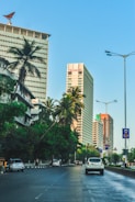 A vibrant street view of a modern Doral neighborhood with palm trees and bright blue skies