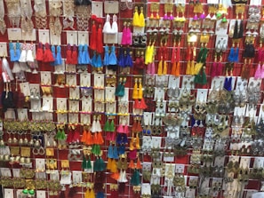 A vibrant gallery wall showcasing various pastel-toned piercing styles and jewelry.