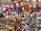 A vibrant display of a wide variety of earrings arranged on a wall, featuring tassels, metallic designs, and colorful beads. The earrings are organized in neat rows, showcasing an array of designs from traditional to modern styles.